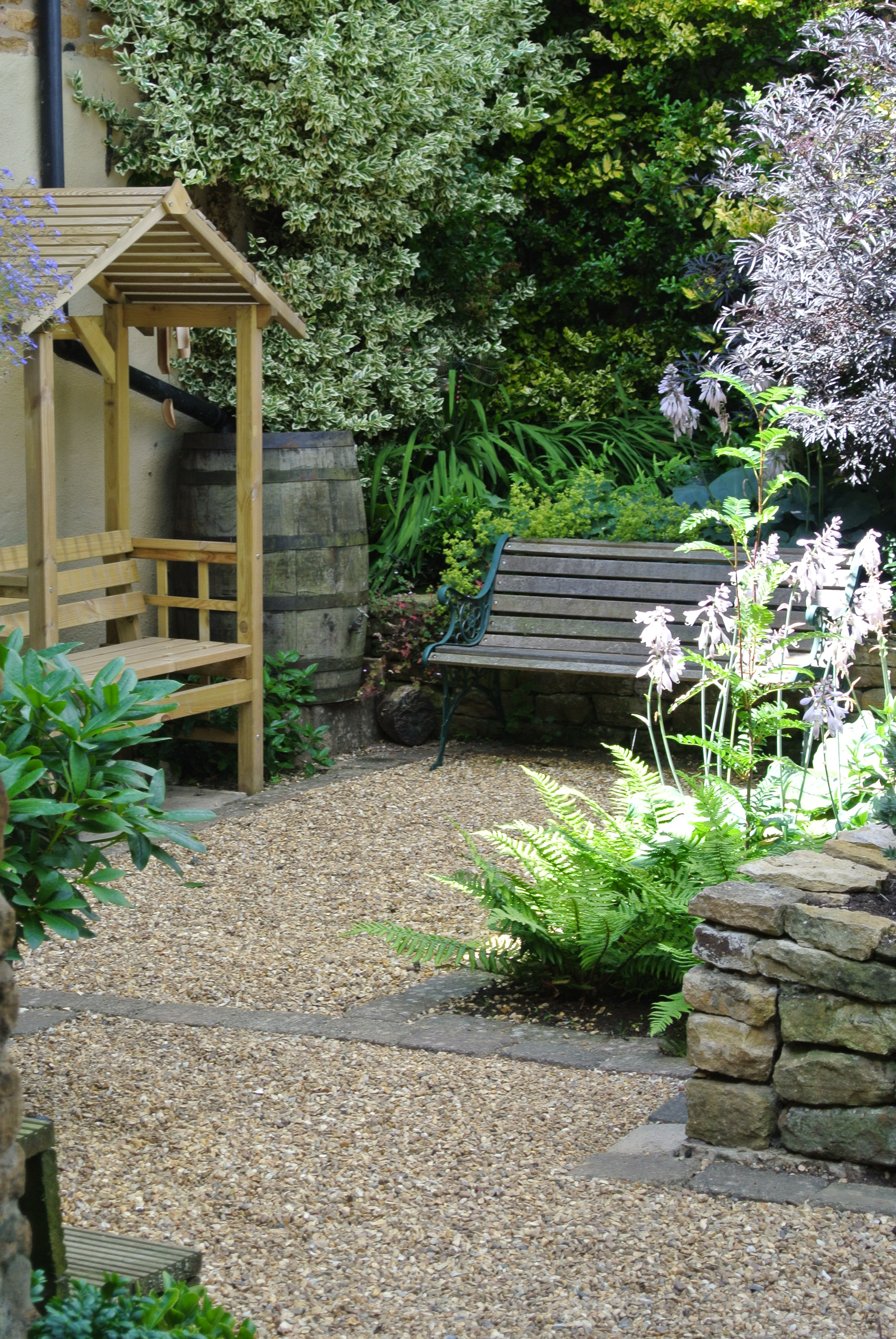 Small Cottage Garden Design For Family In Northampton View Of Shady Seating Area